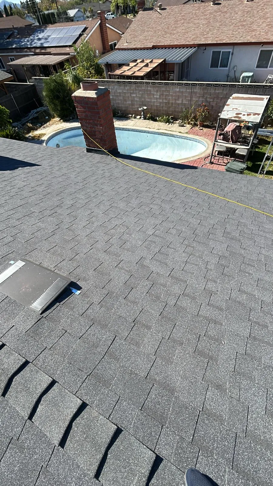 New gray shingle roof overlooking the backyard pool
