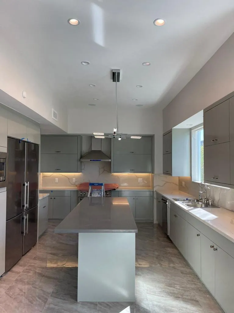 Gray kitchen with island and polished floors