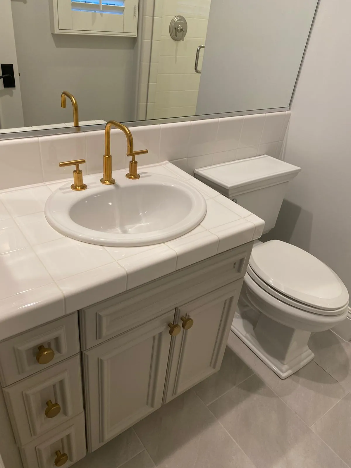 Powder vanity with gold fixtures and marble top