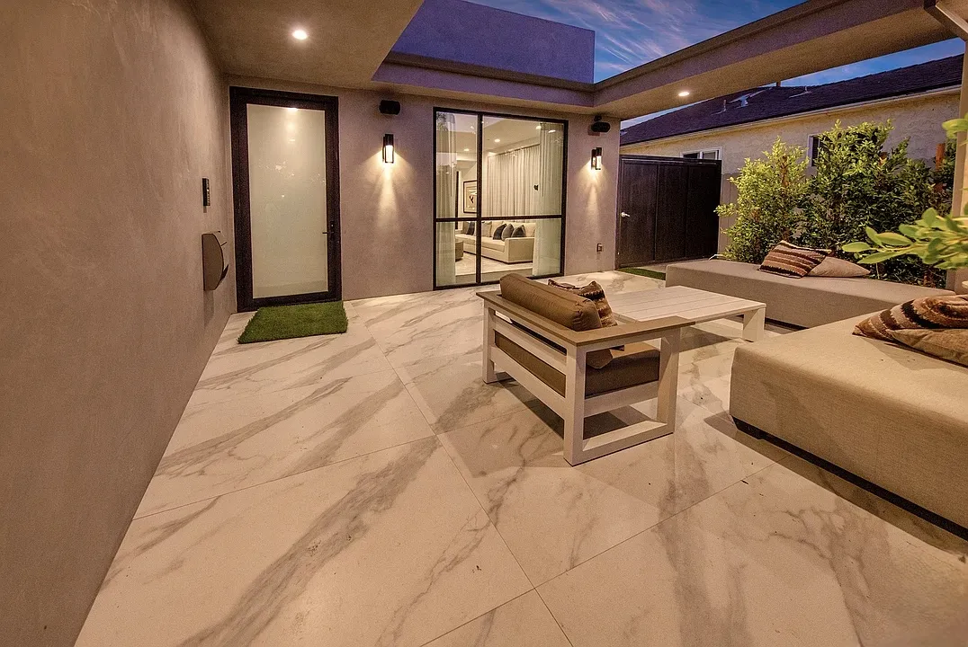 Covered patio with marble tile and built-in seating