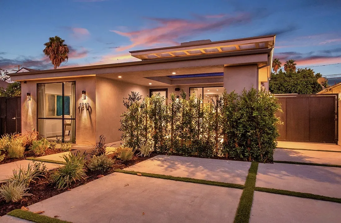 Modern front exterior of the Sherbourne House at dusk with landscape lighting